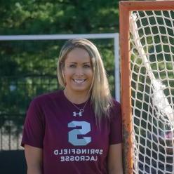 Photo of Jenn Thomas by a lacrosse net